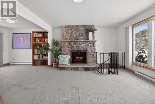 Main level granite fireplace - 1420 Tiny Beaches Road N, Tiny, ON - Indoor With Fireplace