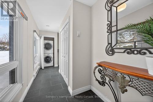 Stacked washer/dryer off the foyer from the garage - 1420 Tiny Beaches Road N, Tiny, ON - Indoor Photo Showing Other Room