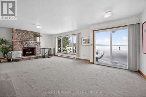Expansive panoramic water views - 1420 Tiny Beaches Road N, Tiny, ON - Indoor Photo Showing Living Room With Fireplace