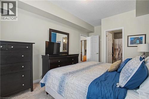 ... and a private ensuite - 2000 Creekside Drive Unit# 708, Hamilton, ON - Indoor Photo Showing Bedroom