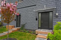 Contemporary facade featuring dark gray textured block siding - 