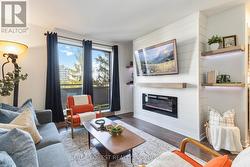 Living Room with electric fire and a treed view - 