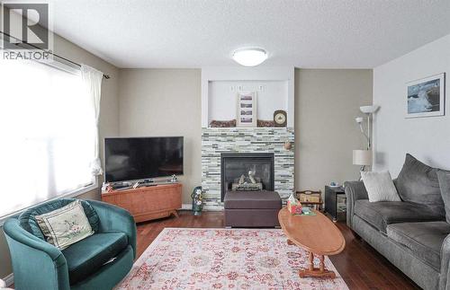 125 Silverado Range Cove Sw, Calgary, AB - Indoor Photo Showing Living Room With Fireplace