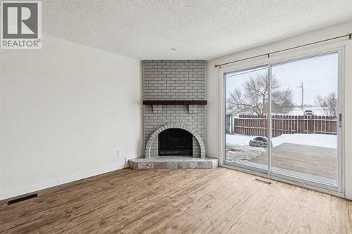 220 Templeby Place Ne, Calgary, AB - Indoor Photo Showing Living Room With Fireplace