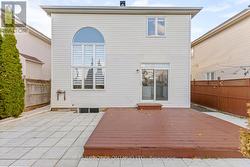 Backyard w/ raised wood deck and patio surround - 