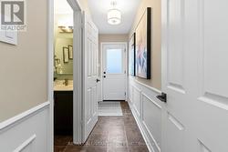 Mud room w powder room access & side door. - 