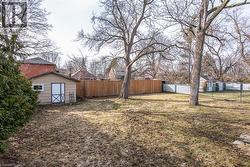 Fenced backyard with an outdoor structure - 
