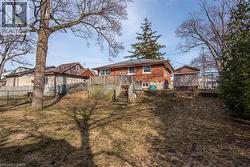 Back of property featuring a deck and brick siding - 