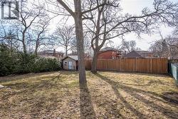 Fenced backyard with an outbuilding - 