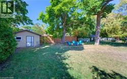 Fenced backyard featuring a shed - 