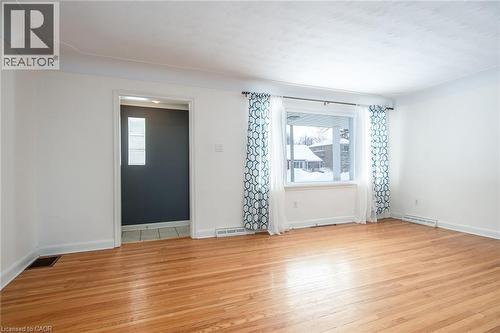 Empty room with light wood-style floors and healthy amount of natural light - 120 Fourth Avenue, Kitchener, ON 
