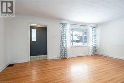 Empty room with light wood-style floors and healthy amount of natural light - 