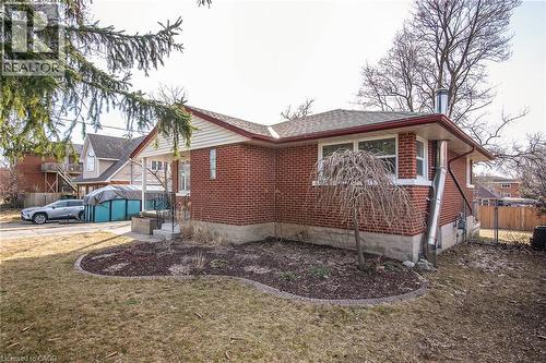 View of side of home with brick siding and a shingled roof - 120 Fourth Avenue, Kitchener, ON 