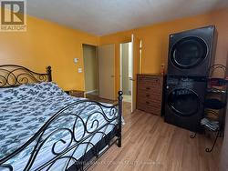 Primary bedroom with laundry. - 