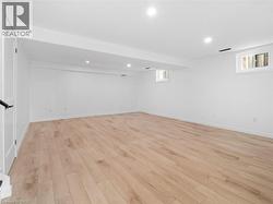 Below grade area with visible vents, plenty of natural light, recessed lighting, and light wood finished floors - 