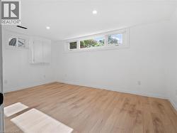 Unfurnished room featuring light wood-style flooring, baseboards, and recessed lighting - 