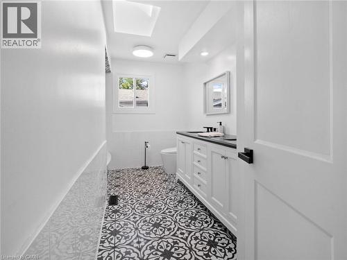 Bathroom featuring tile walls, visible vents, toilet, vanity, and tile patterned flooring - 24 Keefer Road, Thorold, ON - Indoor