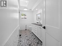 Bathroom featuring tile walls, visible vents, toilet, vanity, and tile patterned flooring - 