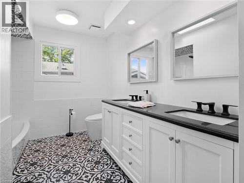 Bathroom featuring visible vents, a sink, toilet, and double vanity - 24 Keefer Road, Thorold, ON - Indoor Photo Showing Bathroom