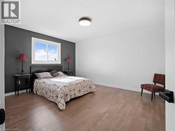 Bedroom with baseboards and wood finished floors - 