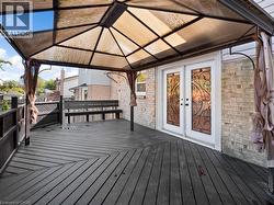 Wooden deck featuring a gazebo and french doors - 