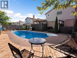 View of pool featuring a patio, a fenced in pool, a fenced backyard, and a deck - 