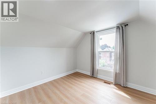 Spacious bedroom with closet & window for natural light. - 15 Barnesdale Avenue N, Hamilton, ON - Indoor Photo Showing Other Room