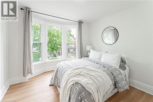 Spacious bedroom with closet & window for natural light. - 15 Barnesdale Avenue N, Hamilton, ON - Indoor Photo Showing Bedroom