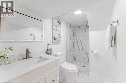 Full bathroom with spacious vanity, separate shower & ready for you! - 15 Barnesdale Avenue N, Hamilton, ON - Indoor Photo Showing Bathroom