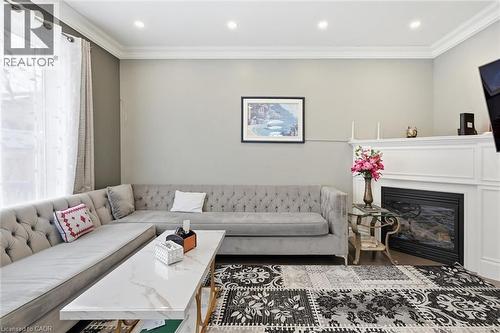 Living area with crown molding, plenty of natural light, a glass covered fireplace, and recessed lighting - 456 Valridge Drive, Ancaster, ON - Indoor Photo Showing Living Room With Fireplace