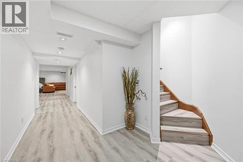 Corridor featuring stairs and light wood-style floors - 456 Valridge Drive, Ancaster, ON - Indoor Photo Showing Other Room