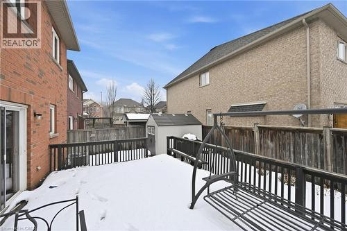 Snow covered deck featuring a shed, a fenced backyard, and a residential view - 456 Valridge Drive, Ancaster, ON - Outdoor With Exterior