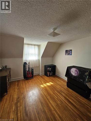 Bonus room featuring wood-type flooring and a textured ceiling - 59 Dunkirk Drive, Hamilton, ON - Indoor