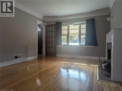 Unfurnished living room with a fireplace and hardwood / wood-style flooring - 59 Dunkirk Drive, Hamilton, ON - Indoor Photo Showing Other Room