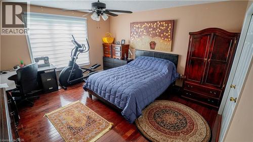 Bedroom with wood-type flooring, a desk, a textured ceiling, and ceiling fan - 44 Dunnigan Drive E, Kitchener, ON - Indoor Photo Showing Bedroom