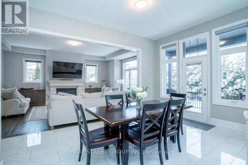 Open Dining Overlooking Family Room - 39 Cairns Gate, King, ON - Indoor Photo Showing Dining Room With Fireplace