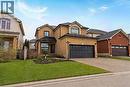 Brick two-story residence featuring a dark shingled roof and an attached two-car garage with a panel-style door - 6 Second Road W, Hamilton, ON  - Outdoor With Facade 