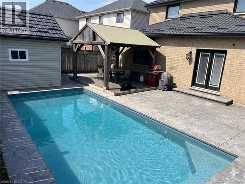 Rectangular in-ground pool with surrounding stamped concrete patio - 6 Second Road W, Hamilton, ON - Outdoor With In Ground Pool With Exterior