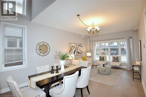Dining area featuring light wood-type flooring and suspended lighting - 5109 Blue Spruce Avenue, Burlington, ON - Indoor Photo Showing Dining Room