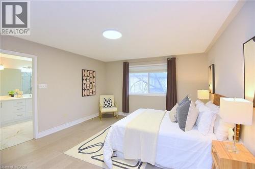 Bedroom with light wood finished floors and ensuite bathroom - 5109 Blue Spruce Avenue, Burlington, ON - Indoor Photo Showing Bedroom