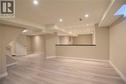 Finished below grade area featuring light wood-style flooring and recessed lighting - 5109 Blue Spruce Avenue, Burlington, ON - Indoor Photo Showing Other Room
