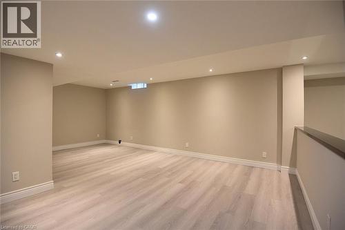 Finished basement with light wood-style floors and recessed lighting - 5109 Blue Spruce Avenue, Burlington, ON - Indoor Photo Showing Other Room