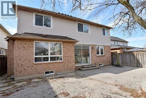 Rear view of property with brick siding and entry steps - 5109 Blue Spruce Avenue, Burlington, ON - Outdoor With Exterior