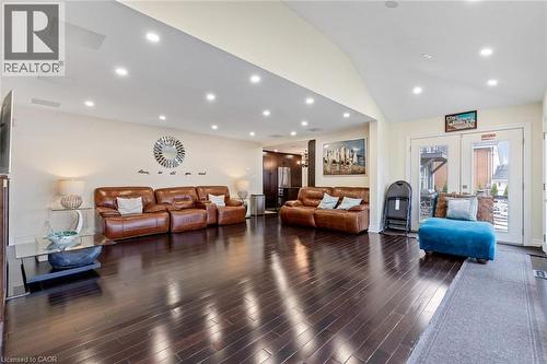 Living room with dark hardwood / wood-style flooring, high vaulted ceiling, and french doors - 1073 North Service Road, Hamilton, ON - Indoor Photo Showing Living Room