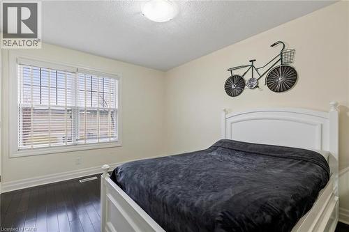 Bedroom featuring a textured ceiling and dark hardwood / wood-style flooring - 1073 North Service Road, Hamilton, ON - Indoor Photo Showing Bedroom