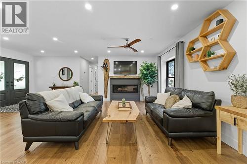 Living room featuring hardwood / wood-style flooring, a fireplace, french doors, recessed lighting, and ceiling fan - 115 Lakeshore Road, Port Burwell, ON - Indoor Photo Showing Living Room With Fireplace