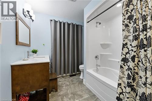 Bathroom with shower / tub combo with curtain, vanity, and a textured ceiling - 115 Lakeshore Road, Port Burwell, ON - Indoor Photo Showing Bathroom