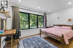 Bedroom with wood finished floors and recessed lighting - 