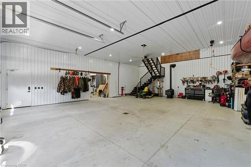 Garage with metal wall and a workshop area - 115 Lakeshore Road, Port Burwell, ON - Indoor Photo Showing Garage
