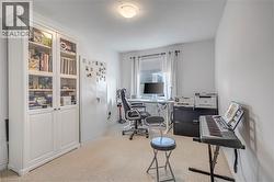 Home office featuring light colored carpet and baseboards - 